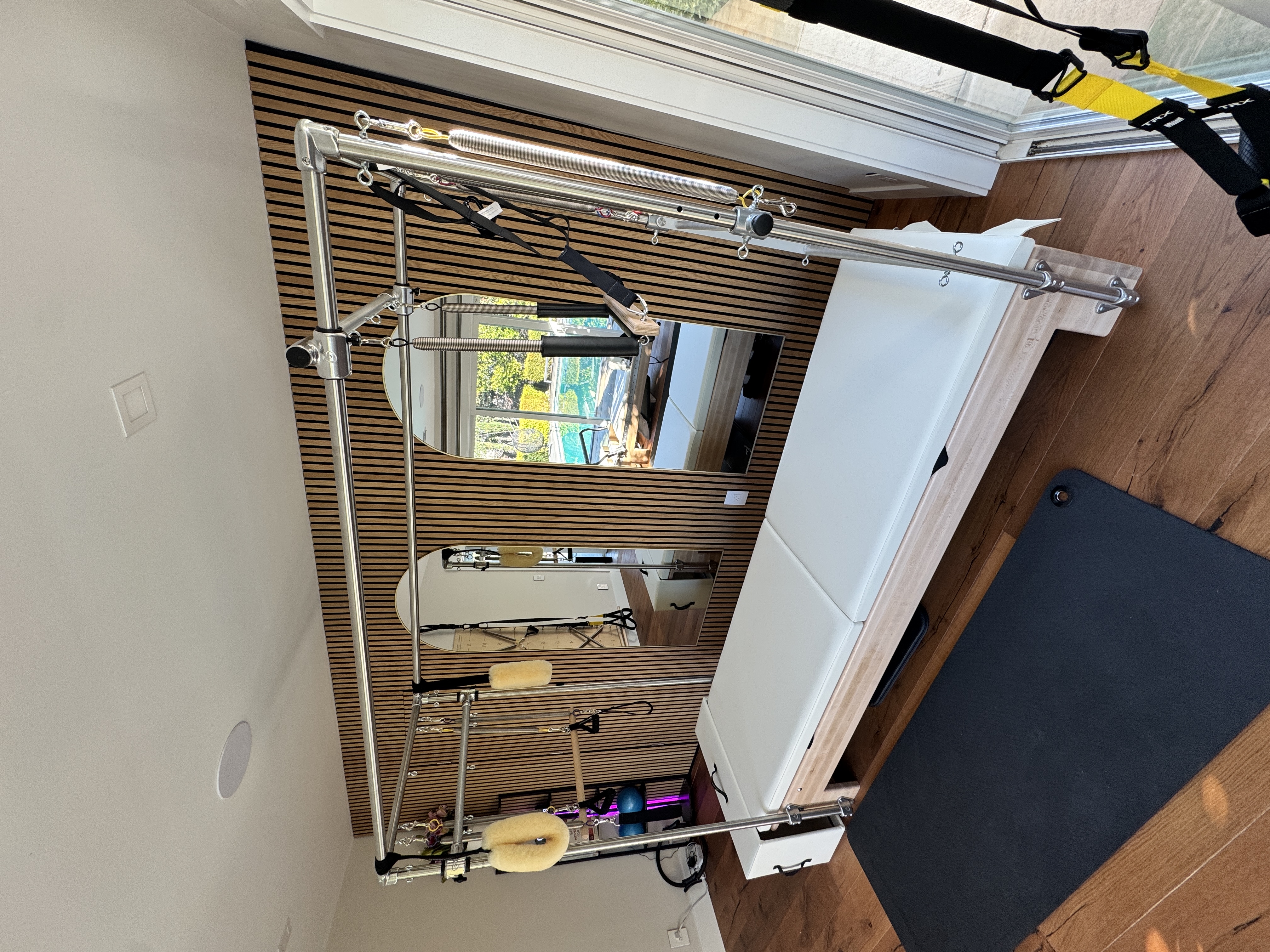 Pilates Cadillac apparatus close-up in studio with warm natural light